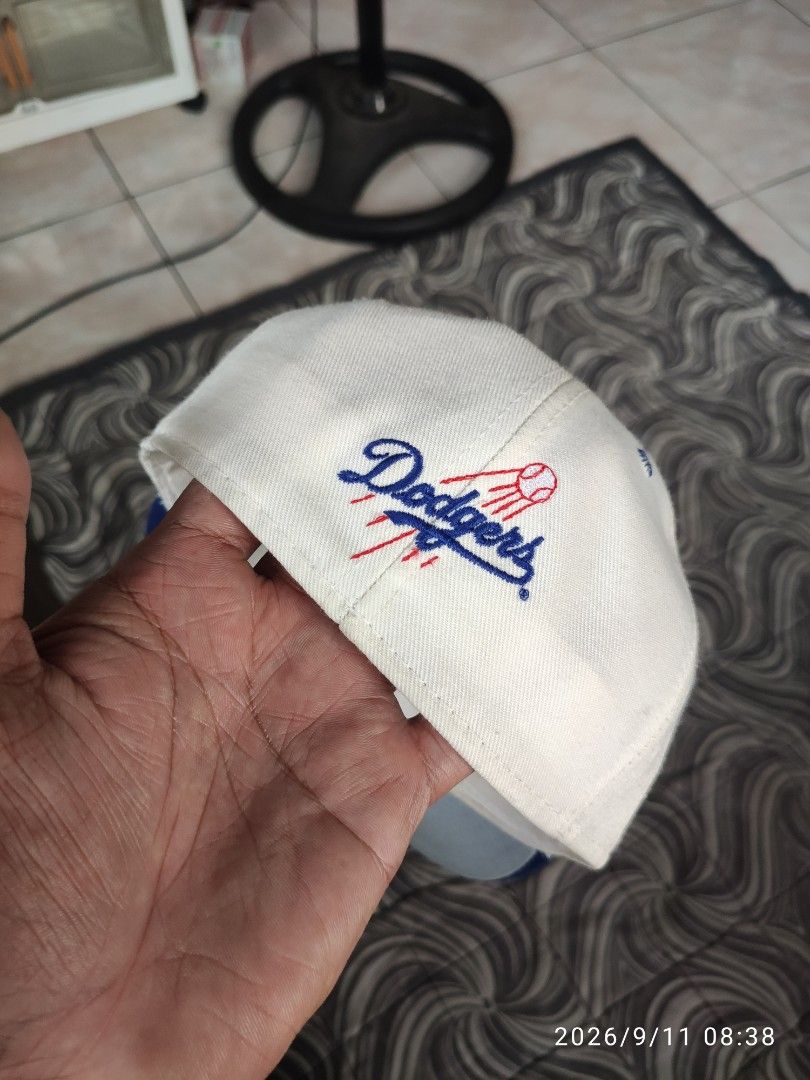 Los Angeles Dodgers Pro-Line Baseball Cap (Category: Caps & Hats) located in Las Pinas. Submitted by vtg_sakalam2021 (Listing ID 1460955839, Image 2). Description: - Classic white and blue Los Angeles Dodgers cap - Features embroidered 'Dodgers' logo on the front - Smaller embroidered logo on the side - Pro-Line tag inside - fitted hat 7 1/8 - Ideal for any Dodgers fan.