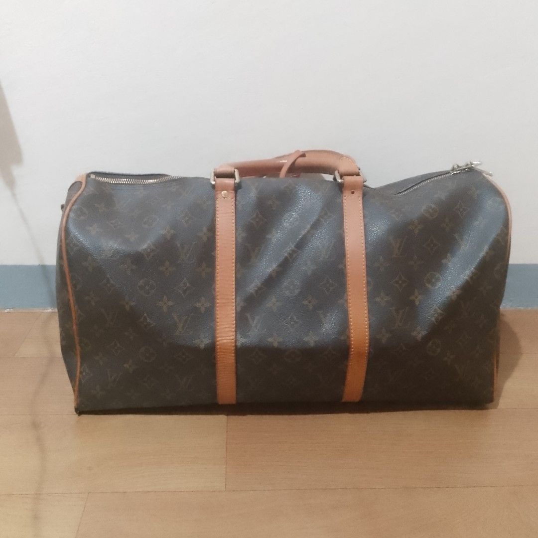 Louis Vuitton Monogram Keepall 55 Duffle Bag (Category: Luxury Bags & Wallets) located in Valenzuela. Submitted by jmateo52697 (Listing ID 1461053336, Image 1). Description: - Classic Louis Vuitton Keepall 50 - Monogram canvas with tan leather trim and handles - Ideal for weekend trips or carry-on luggage - Spacious interior - Smoothly functioning zippers - A timeless piece for travel.
