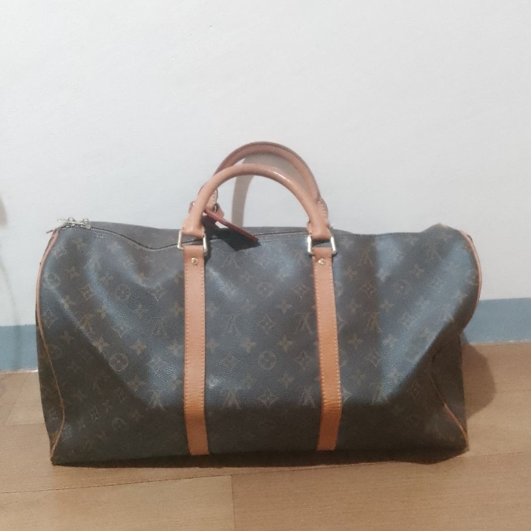 Louis Vuitton Monogram Keepall 55 Duffle Bag (Category: Luxury Bags & Wallets) located in Valenzuela. Submitted by jmateo52697 (Listing ID 1461053336, Image 2). Description: - Classic Louis Vuitton Keepall 50 - Monogram canvas with tan leather trim and handles - Ideal for weekend trips or carry-on luggage - Spacious interior - Smoothly functioning zippers - A timeless piece for travel.
