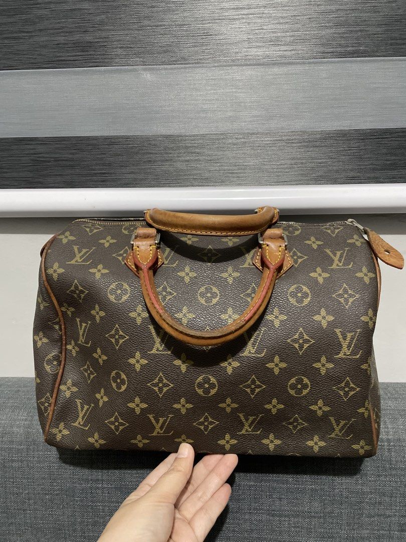 Louis Vuitton Monogram Speedy 30 Handbag (Category: Luxury Bags & Wallets) located in Pasig City. Submitted by roseyyylife (Listing ID 1461108974, Image 2). Description: - Classic Louis Vuitton Speedy 30 - Iconic monogram canvas - Leather handles show some wear from use - Zipper works smoothly - Timeless piece for everyday - Great for carrying essentials - This is vintage and has been repaired and mended. .
