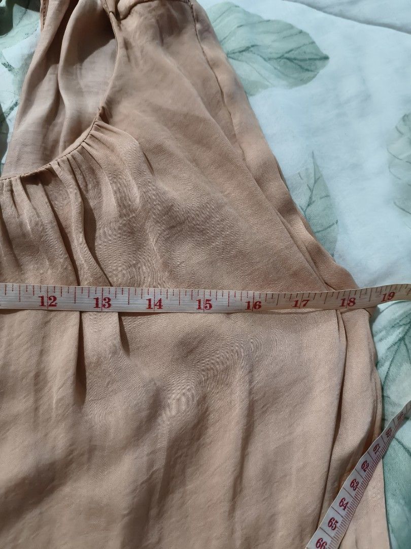 Mango Basics Peach Gathered Neck Sleeveless Blouse Top (Category: Blouses) located in Tarlac. Submitted by momma02 (Listing ID 1460987231, Image 3). Description: - Mango Basics sleeveless top - Lovely blush peach color - Gathered neckline with tie detail - Lightweight fabric, drapes nicely - Perfect for casual or dressed-up looks - Approx. measurements: 17" pit to pit, 23" length -💕last pic for reference of when worn. neckline is lower on the ac