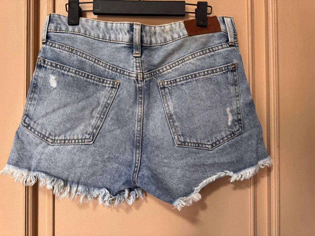 Mango Distressed Denim Shorts with Frayed Hem (Category: Shorts) located in Marikina City. Submitted by 1stuffshop (Listing ID 1460972464, Image 2). Description: - Brand: Mango - Style: Light wash denim shorts - Features: Distressed details, frayed hem - Pockets: Classic five-pocket styling - Closure: Button and zip - Occasion: Casual wear - Versatility: Easy to pair with any top.