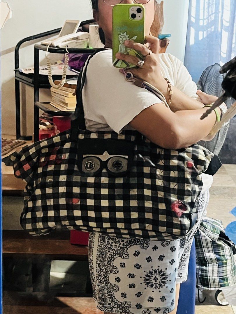 Marc Jacobs Black and White Gingham Tote Bag (Category: Maternity Care) located in Mandaue City. Submitted by chuchi152615 (Listing ID 1461087128, Image 3). Description: - Stylish black and white gingham large tote bag - Unique front pocket designed like eyes - Durable leather handles and trim - Ample interior space for essentials - Ideal for travel or everyday use.