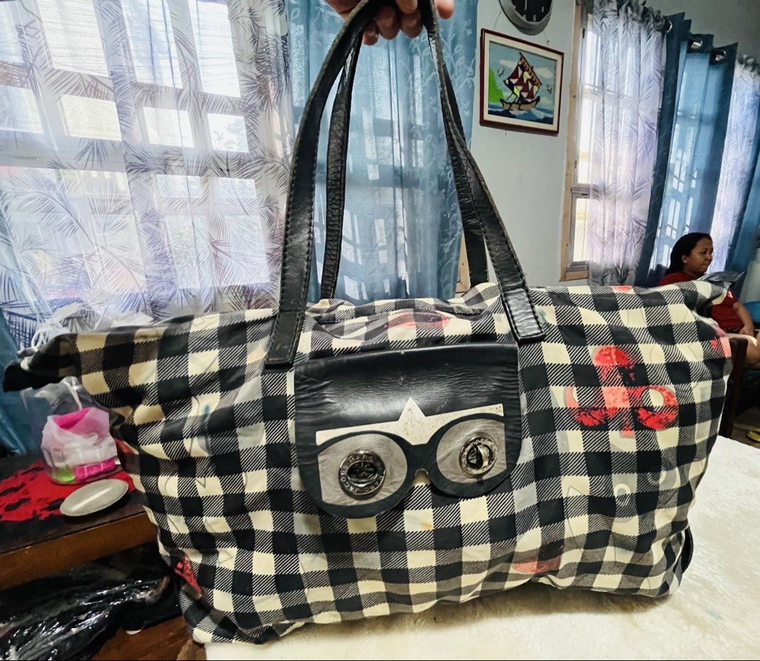Marc Jacobs Black and White Gingham Tote Bag (Category: Maternity Care) located in Mandaue City. Submitted by chuchi152615 (Listing ID 1461087128, Image 1). Description: - Stylish black and white gingham large tote bag - Unique front pocket designed like eyes - Durable leather handles and trim - Ample interior space for essentials - Ideal for travel or everyday use.