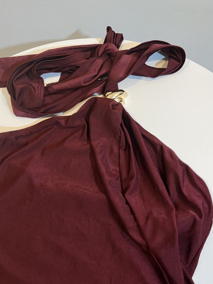 Maroon Halter Top with Gold Ring Detail (Category: Sleeveless) located in Manila. Submitted by xoshushi.dcltr (Listing ID 1460973885, Image 2). Description: - Chic maroon halter top - Features a stylish gold ring detail at the front - Secure tie-up closure at the neck - Fabric has a subtle, elegant sheen - Estimated size: Small (S) - Ideal for evening events, parties, or a night out.