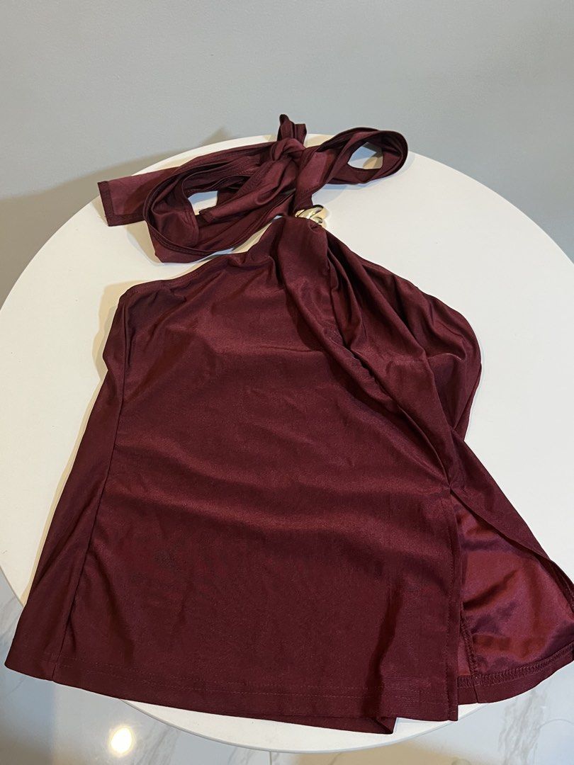 Maroon Halter Top with Gold Ring Detail (Category: Sleeveless) located in Manila. Submitted by xoshushi.dcltr (Listing ID 1460973885, Image 1). Description: - Chic maroon halter top - Features a stylish gold ring detail at the front - Secure tie-up closure at the neck - Fabric has a subtle, elegant sheen - Estimated size: Small (S) - Ideal for evening events, parties, or a night out.