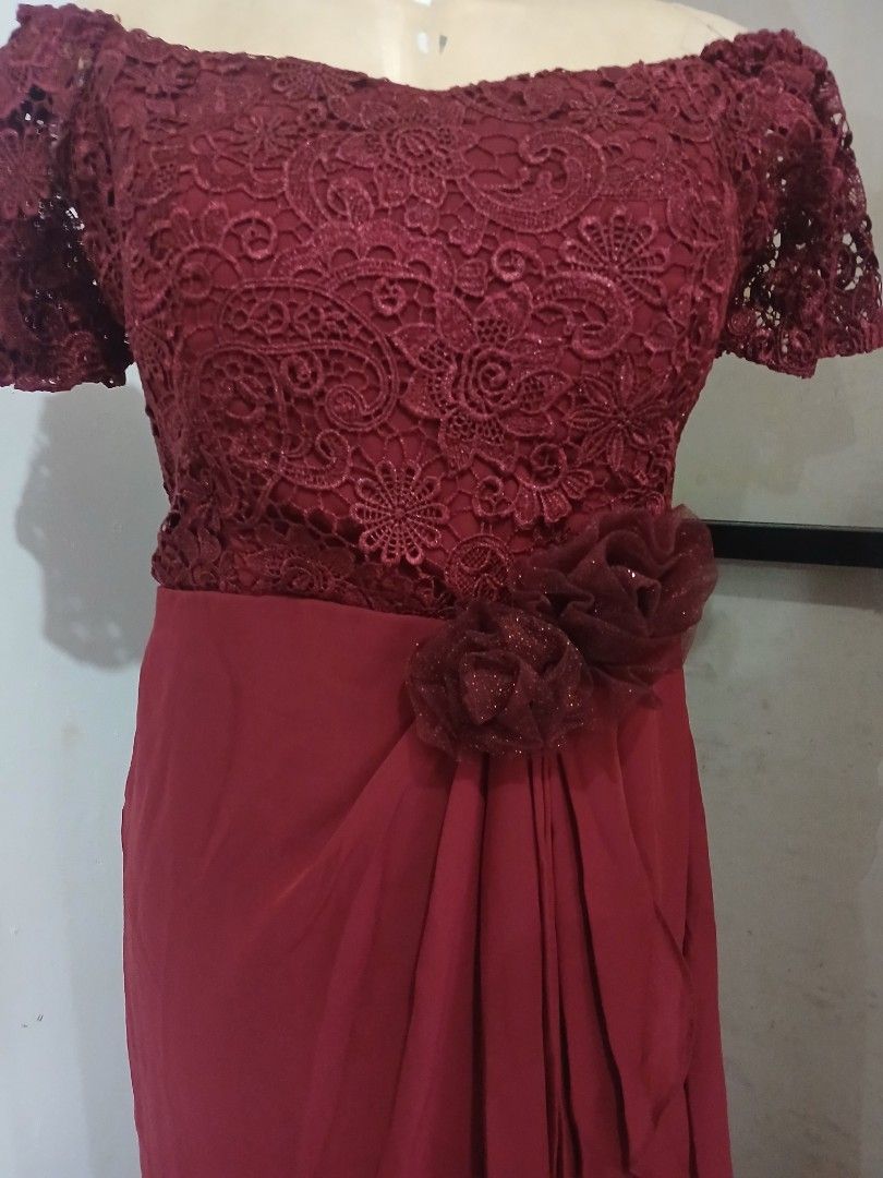 Maroon Lace Overlay Evening Gown (Category: Evening dresses & gowns) located in Abucay. Submitted by mimasshop (Listing ID 1461114748, Image 2). Description: - Beautiful maroon evening gown - Delicate lace overlay on bodice and sleeves - Flattering draped skirt - Floral embellishment at the waist - Ideal for formal events and weddings - Comfortable and chic design.