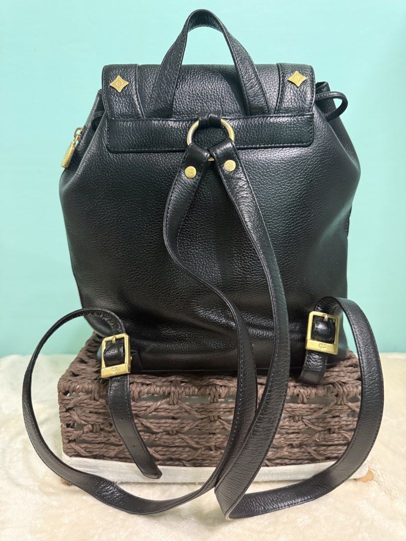 MCM Black Leather Backpack with Gold Hardware (Category: Backpacks) located in Davao. Submitted by annabrd0710 (Listing ID 1461038277, Image 3). Description: - Classic MCM backpack in black leather - Iconic MCM logo and gold-tone hardware - Secure drawstring closure with a flap top - Convenient front pocket for easy access - Adjustable shoulder straps for personalized comfort - Authentic from Germany - No issues.