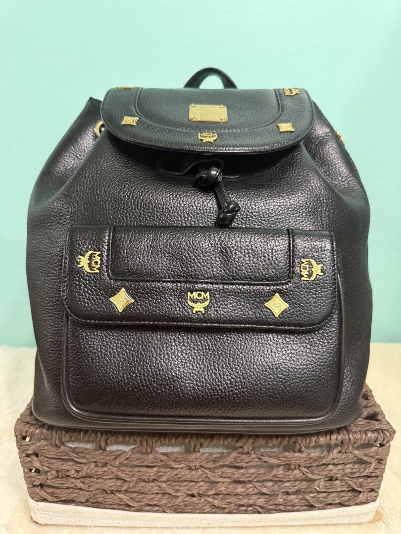 MCM Black Leather Backpack with Gold Hardware (Category: Backpacks) located in Davao. Submitted by annabrd0710 (Listing ID 1461038277, Image 2). Description: - Classic MCM backpack in black leather - Iconic MCM logo and gold-tone hardware - Secure drawstring closure with a flap top - Convenient front pocket for easy access - Adjustable shoulder straps for personalized comfort - Authentic from Germany - No issues.