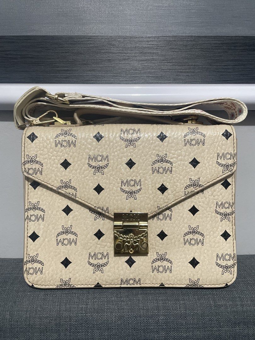 MCM Monogram Shoulder Bag (Category: Luxury Bags & Wallets) located in Pasig City. Submitted by roseyyylife (Listing ID 1461107821, Image 2). Description: - Authentic MCM monogram shoulder bag - Features gold hardware and MCM logo clasp - Versatile with a top handle and detachable shoulder strap - Interior includes a zip pocket and multiple compartments - Ideal for everyday use.