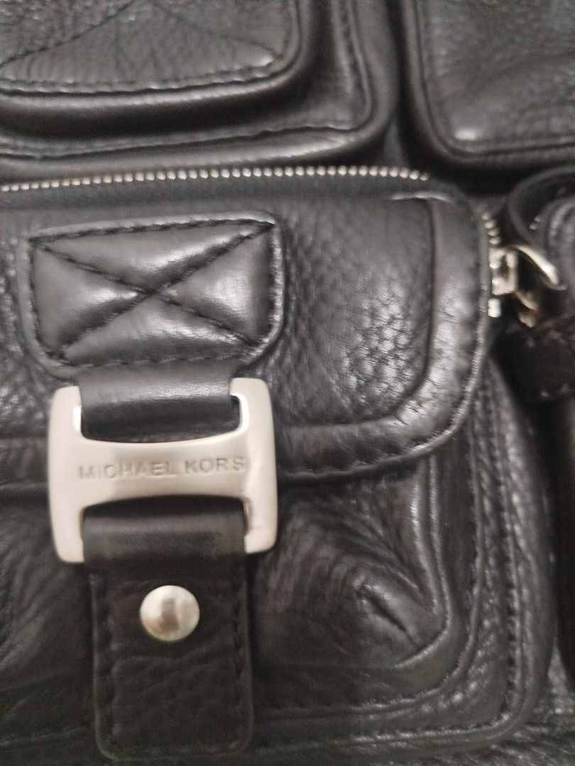 Michael Kors Black Leather Multi-Pocket Tote Bag (Category: Luxury Bags & Wallets) located in Quezon City. Submitted by plus4lessshop (Listing ID 1461108128, Image 2). Description: - Genuine Michael Kors black leather tote bag. - Convenient front pockets for easy access. - Secure zip-top closure for the main compartment. - Interior includes a zip pocket and slip pockets for organization. - Ideal everyday bag..