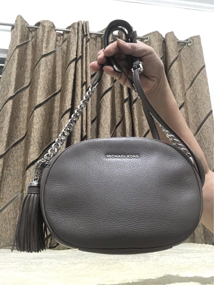 Michael Kors Grey Leather Tassel Shoulder Bag (Category: Luxury Bags & Wallets) located in Rizal. Submitted by elviedc2420209 (Listing ID 1461054403, Image 1). Description: - Michael Kors grey leather shoulder bag - Stylish tassel detail - Chic silver chain strap - Interior card slot - Secure zipper closure - Ideal for everyday wear.