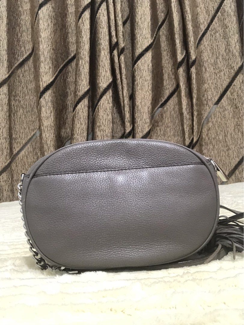Michael Kors Grey Leather Tassel Shoulder Bag (Category: Luxury Bags & Wallets) located in Rizal. Submitted by elviedc2420209 (Listing ID 1461054403, Image 3). Description: - Michael Kors grey leather shoulder bag - Stylish tassel detail - Chic silver chain strap - Interior card slot - Secure zipper closure - Ideal for everyday wear.