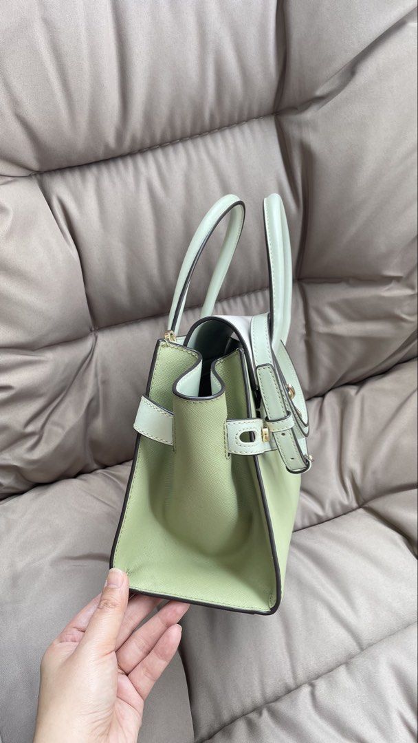 Michael Kors Handbag - Sage Green & White (Category: Luxury Bags & Wallets) located in Pasig City. Submitted by roseyyylife (Listing ID 1461100526, Image 2). Description: 🛍️ Up for grabs is this super chic Michael Kors Carmen handbag in a lovely sage green and white combo. It's got that classic MK charm with gold hardware that just pops! You can carry it by the top handles or sling it over your shoulder with the detachable strap – so versatile! 