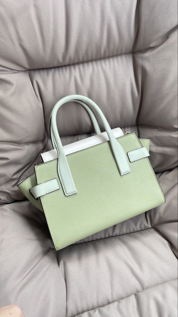 Michael Kors Handbag - Sage Green & White (Category: Luxury Bags & Wallets) located in Pasig City. Submitted by roseyyylife (Listing ID 1461100526, Image 3). Description: 🛍️ Up for grabs is this super chic Michael Kors Carmen handbag in a lovely sage green and white combo. It's got that classic MK charm with gold hardware that just pops! You can carry it by the top handles or sling it over your shoulder with the detachable strap – so versatile! 