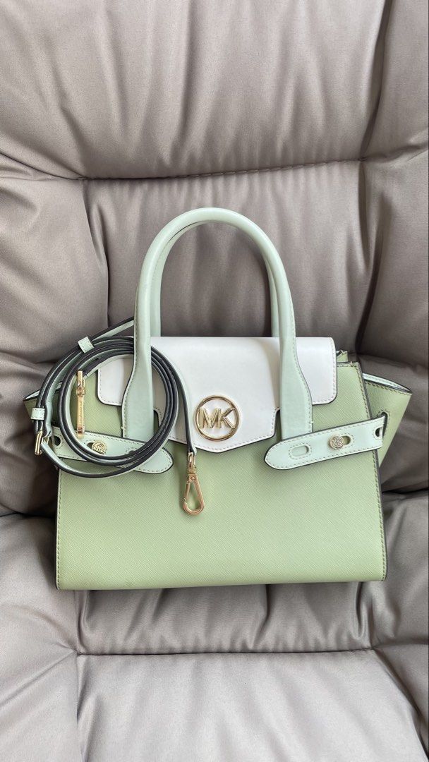 Michael Kors Handbag - Sage Green & White (Category: Luxury Bags & Wallets) located in Pasig City. Submitted by roseyyylife (Listing ID 1461100526, Image 1). Description: 🛍️ Up for grabs is this super chic Michael Kors Carmen handbag in a lovely sage green and white combo. It's got that classic MK charm with gold hardware that just pops! You can carry it by the top handles or sling it over your shoulder with the detachable strap – so versatile! 