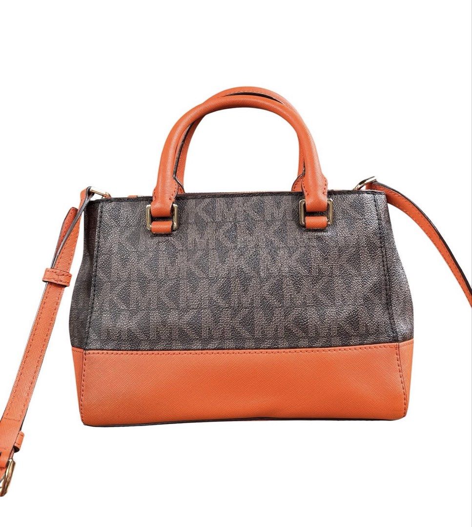 Michael Kors Monogram Canvas Leather Satchel Orange (Category: Cross-body Bags) located in Tuguegarao City. Submitted by closet_jz (Listing ID 1460941478, Image 3). Description: - Authentic Michael Kors satchel bag - Signature MK monogram canvas - Stylish orange leather trim - Comfortable top handles - Detachable shoulder strap for versatility - Secure zipper closure - Interior pockets for organization - Ideal size for everyday essentials - Clean
