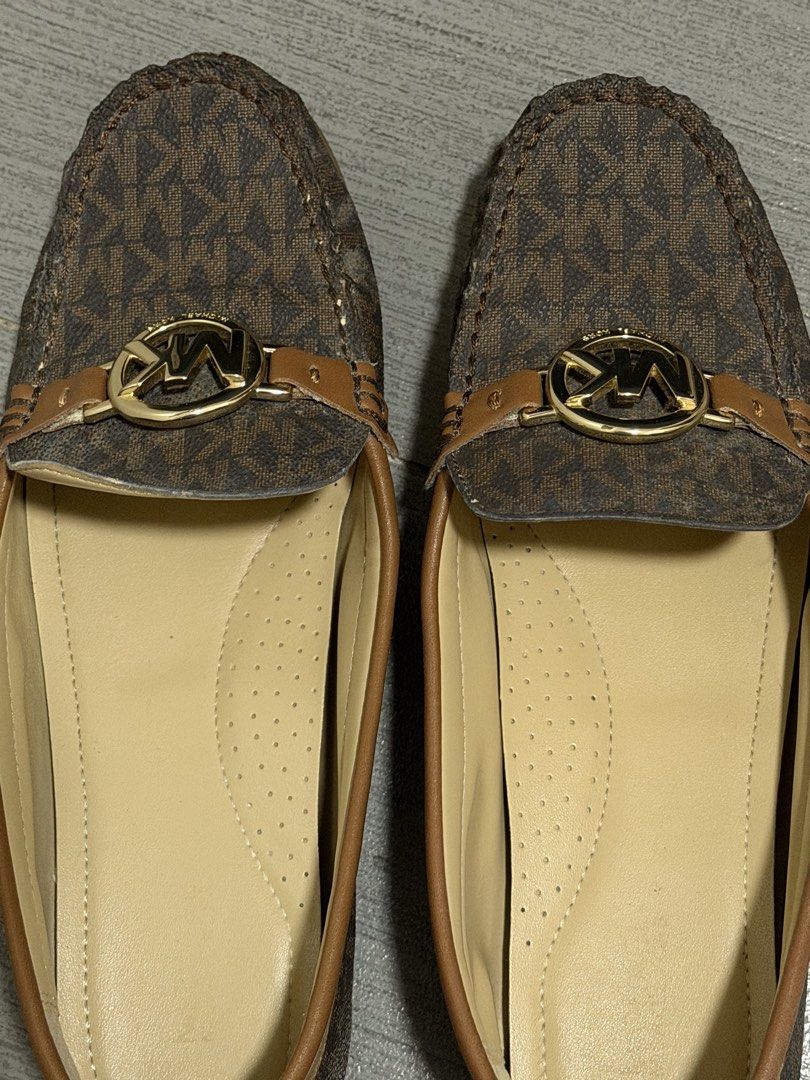 Michael Kors Monogram Loafers (Category: Loafers) located in Pasig City. Submitted by karcart (Listing ID 1461010258, Image 1). Description: - Authentic Michael Kors loafers - Classic MK monogram print in brown and tan - Features gold MK logo hardware on the front strap - Comfortable slip-on style - Versatile for both casual and dressy occasions.