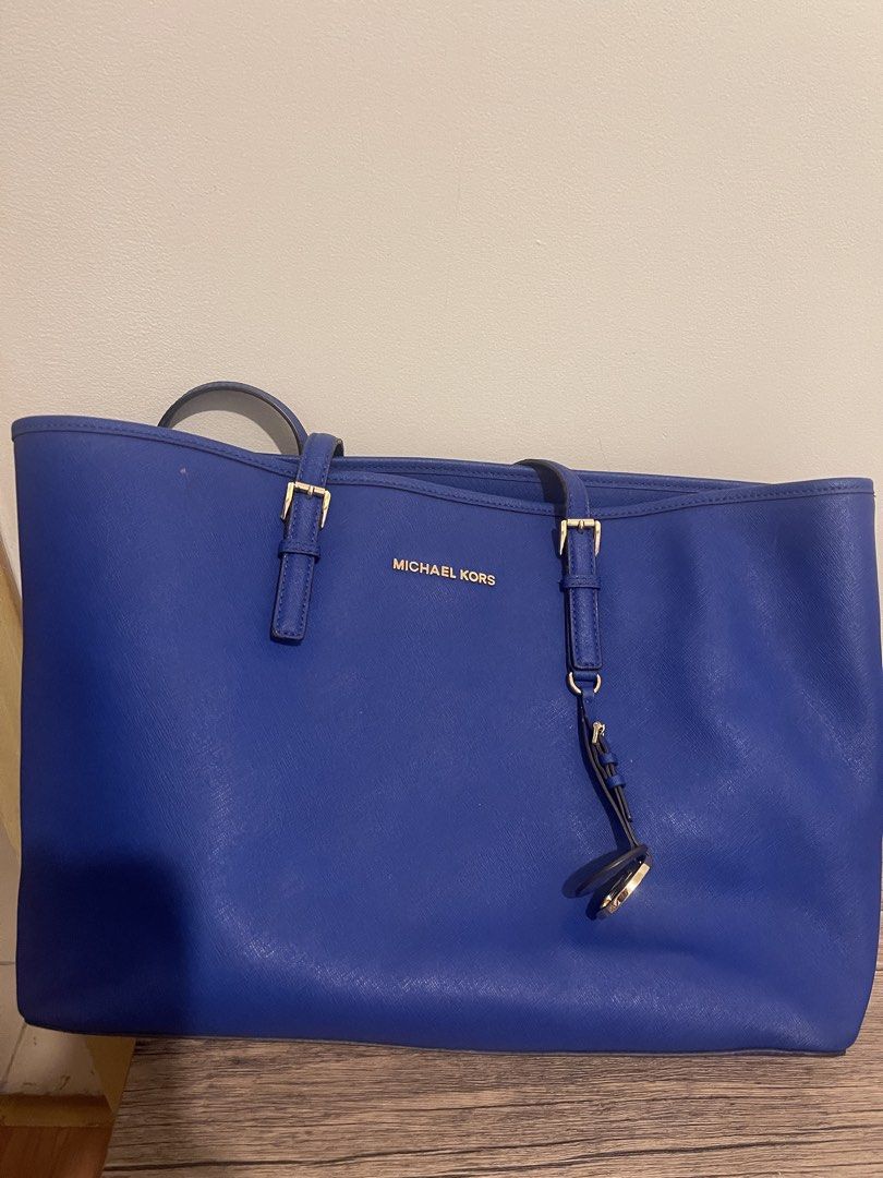 Michael Kors Tote Bag - Royal Blue (Category: Tote Bags) located in Taguig. Submitted by sellall37207 (Listing ID 1461111776, Image 1). Description: - Royal blue Michael Kors tote bag - Elegant gold hardware details - Spacious interior, ideal for everyday essentials - Features a charming strap accent - Clean and meticulously maintained.