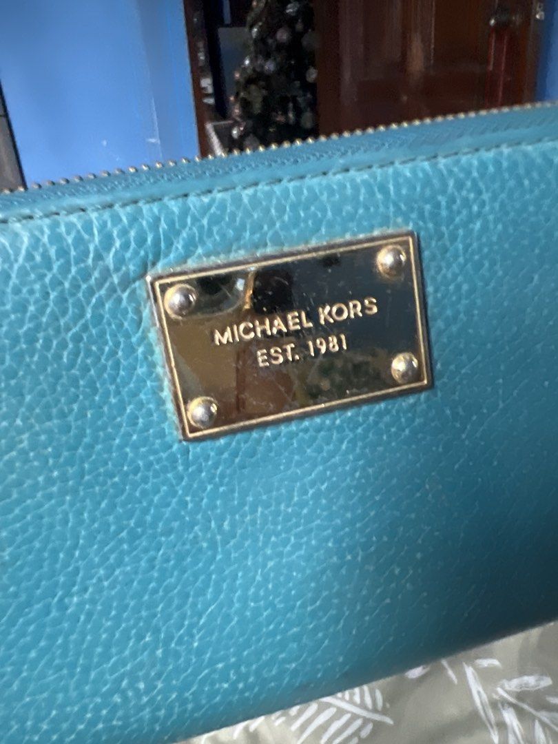 Michael Kors Zip Around Wallet Teal (Category: Wallets & Card holders) located in Lipa City. Submitted by wen_68 (Listing ID 1460987391, Image 2). Description: - Teal Michael Kors wallet - Zip-around closure - Ample card slots and compartments - Gold-tone hardware - Perfect for organizing essentials - Classic Michael Kors accessory.