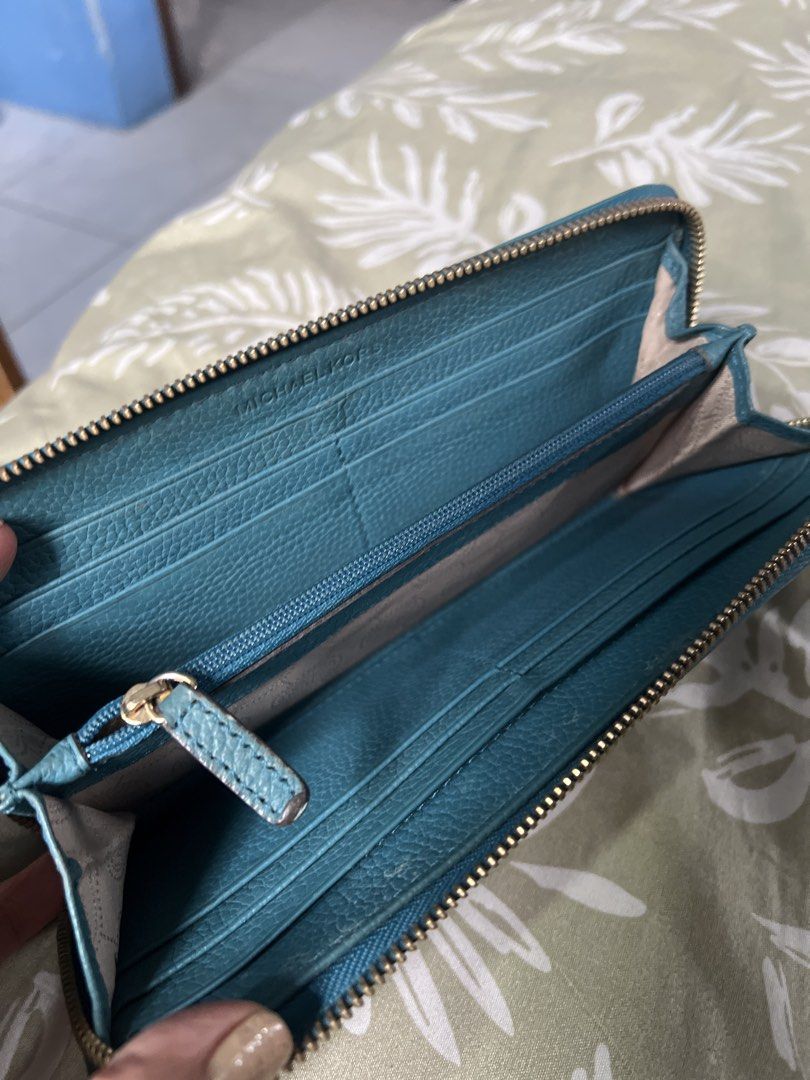 Michael Kors Zip Around Wallet Teal (Category: Wallets & Card holders) located in Lipa City. Submitted by wen_68 (Listing ID 1460987391, Image 3). Description: - Teal Michael Kors wallet - Zip-around closure - Ample card slots and compartments - Gold-tone hardware - Perfect for organizing essentials - Classic Michael Kors accessory.
