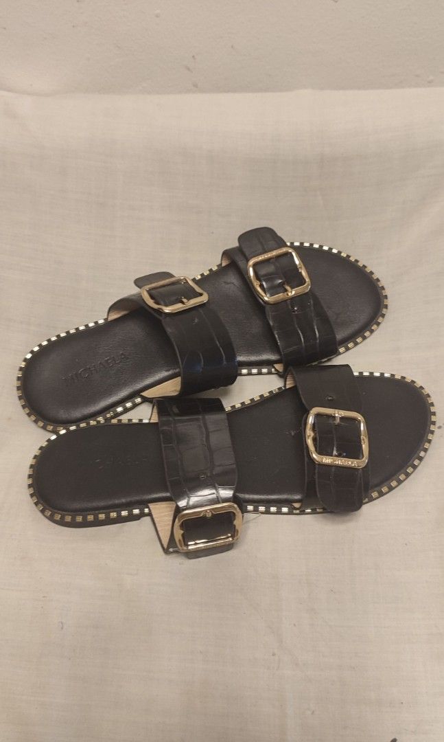 MICHAELA Black Crocodile Embossed Double Strap Sandals (Category: Flats & Sandals) located in Manila. Submitted by thea.magz (Listing ID 1461008407, Image 2). Description: - Brand: MICHAELA - Style: Slide Sandals - Color: Black - Design: Double strap with gold buckles - Texture: Crocodile embossed on straps - Embellishments: Gold stud detailing around the sole - Closure: Easy slip-on - Occasion: Casual wear RFS: Decluttering Shipping c/o buyer.