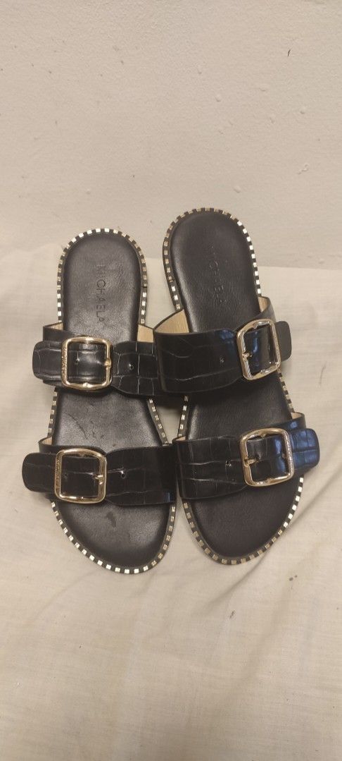MICHAELA Black Crocodile Embossed Double Strap Sandals (Category: Flats & Sandals) located in Manila. Submitted by thea.magz (Listing ID 1461008407, Image 1). Description: - Brand: MICHAELA - Style: Slide Sandals - Color: Black - Design: Double strap with gold buckles - Texture: Crocodile embossed on straps - Embellishments: Gold stud detailing around the sole - Closure: Easy slip-on - Occasion: Casual wear RFS: Decluttering Shipping c/o buyer.
