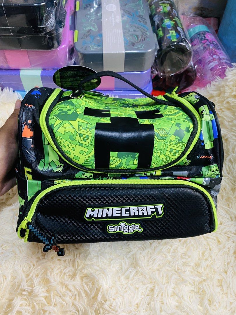 Minecraft Smiggle Lunch Bag Creeper Design (Category: Stationery & School Supplies) located in Manila. Submitted by mariamicaella24 (Listing ID 1461094449, Image 2). Description: - Features iconic Minecraft Creeper face - Front pocket with Minecraft and Smiggle logos - Secure zip closure - Ideal for school lunches or picnic snacks - A hit with kids!.