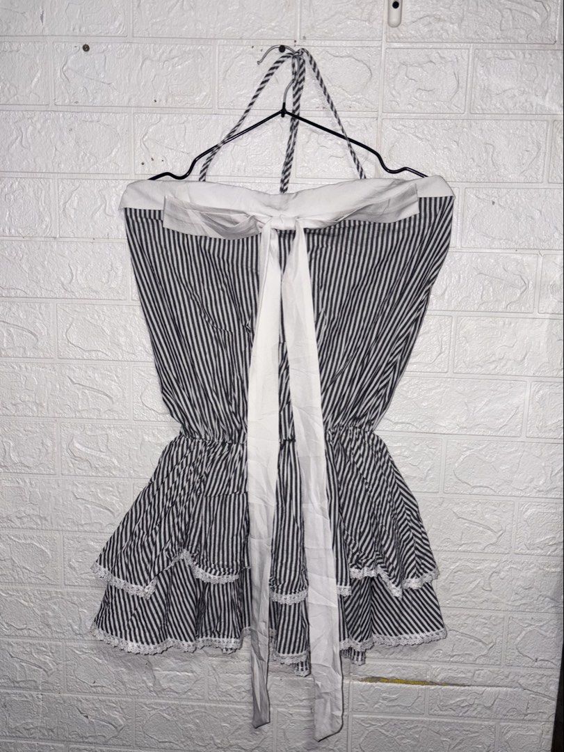 Mini Backless Dress (Category: Dresses) located in Manila. Submitted by _noname.shop (Listing ID 1461052279, Image 1). Description: - Mini backless dress - Size: S (US 4 / UK 8 / EU 36) - can fit to Medium - Color: Black and white stripes - Features: Halter neck, backless design, tiered ruffled skirt with lace trim, cinched waist with tie - Condition: 4/5 - Style: Flirty and chic.