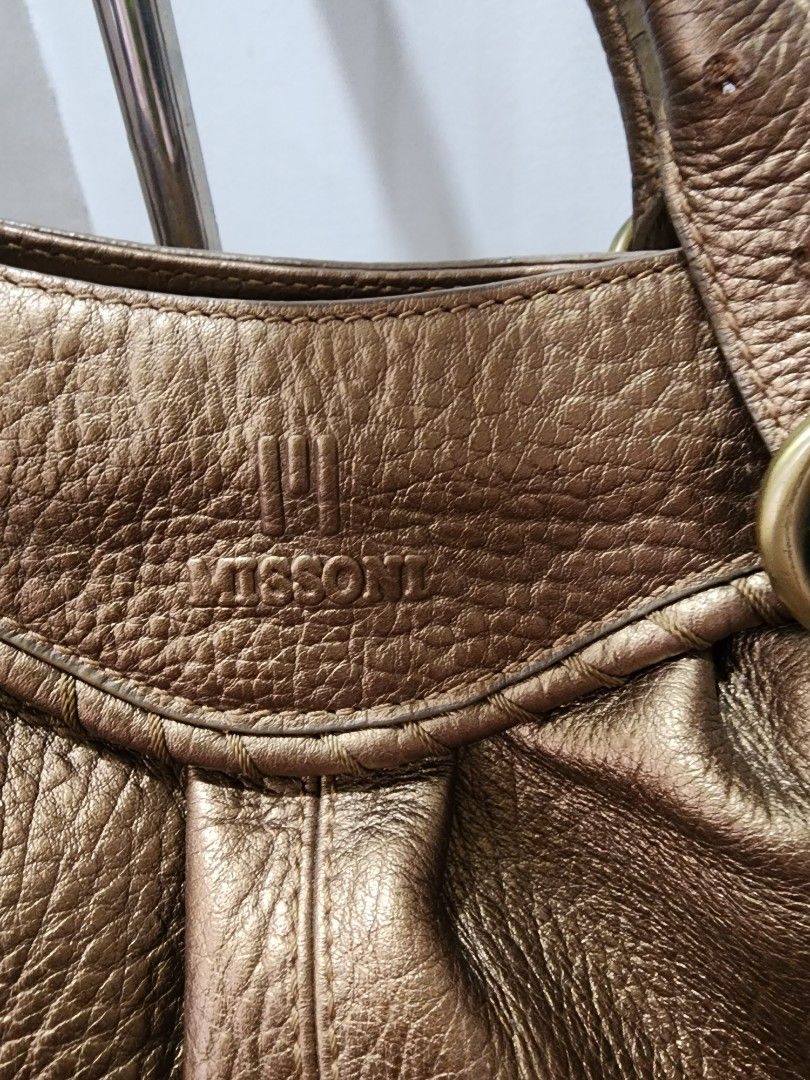 Missoni Metallic Bronze Leather Shoulder Bag (Category: Luxury Bags & Wallets) located in Manila. Submitted by babygirl.luxxe (Listing ID 1461061700, Image 2). Description: - Metallic bronze textured leather shoulder bag - Gold-tone hardware - Multiple interior compartments and zip pockets - Missoni logo printed lining - Ideal everyday bag with a stylish shine.