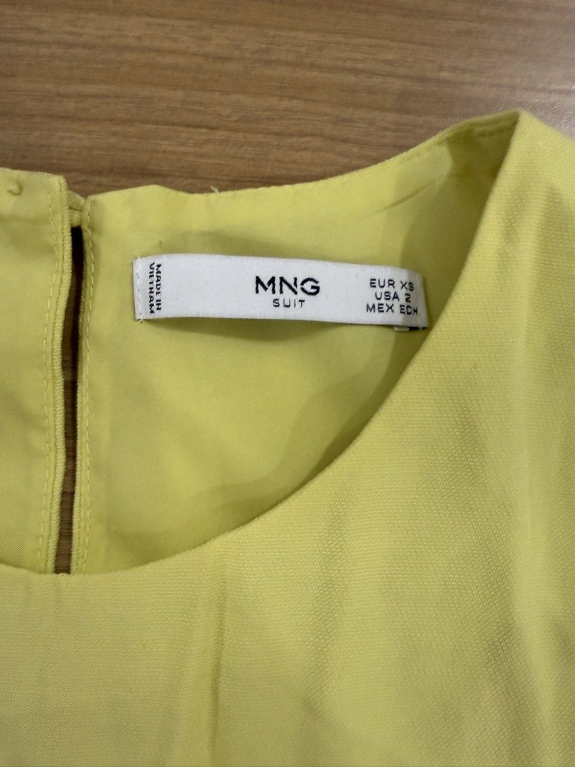 MNG Yellow Sleeveless Layered Top (Category: Sleeveless) located in Marikina City. Submitted by velune (Listing ID 1461009658, Image 3). Description: - Yellow MNG sleeveless top - Size XS - Layered hem detail - Button closure at the back with a keyhole opening - With matching shorts.