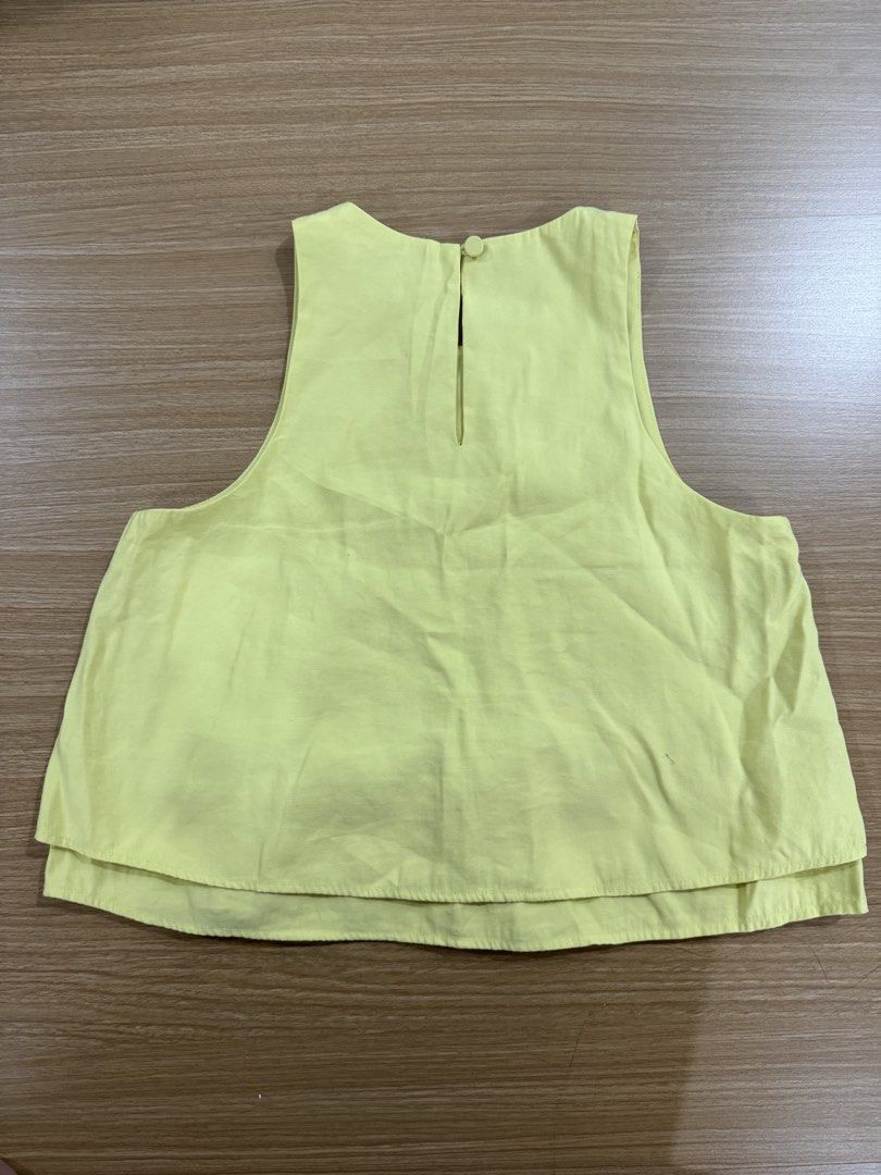 MNG Yellow Sleeveless Layered Top (Category: Sleeveless) located in Marikina City. Submitted by velune (Listing ID 1461009658, Image 2). Description: - Yellow MNG sleeveless top - Size XS - Layered hem detail - Button closure at the back with a keyhole opening - With matching shorts.