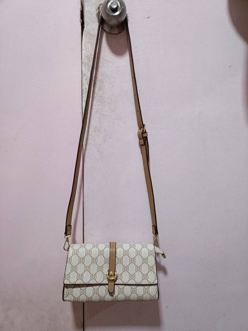 Monogram Crossbody Bag with Tan Accents (Category: Cross-body Bags) located in Malabon City. Submitted by coollion.15fe1d (Listing ID 1461074589, Image 1). Description: - Cute monogram crossbody bag - Tan strap and buckle detail - Magnetic snap closure on flap - Interior zippered compartment - Approximate measurements: 8" W x 4" H - Ideal for everyday use.