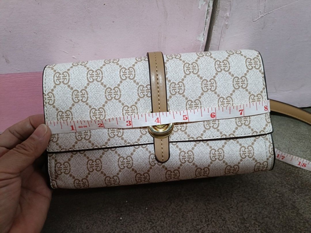 Monogram Crossbody Bag with Tan Accents (Category: Cross-body Bags) located in Malabon City. Submitted by coollion.15fe1d (Listing ID 1461074589, Image 3). Description: - Cute monogram crossbody bag - Tan strap and buckle detail - Magnetic snap closure on flap - Interior zippered compartment - Approximate measurements: 8" W x 4" H - Ideal for everyday use.