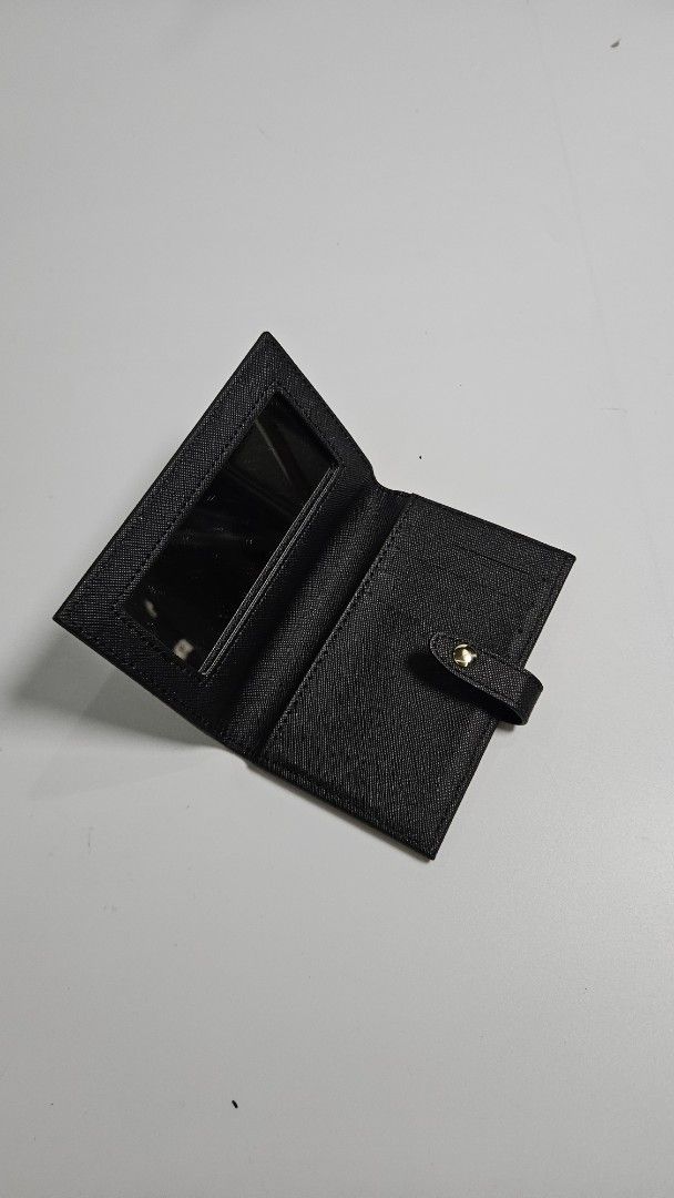 Moschino compact leather wallet (Category: Wallets & Card holders) located in Alfonso. Submitted by jbcamet (Listing ID 1461042020, Image 2). Description: - Brand: Moschino - Type: Compact Wallet - Material: Leather - Color: Black - Features: Embossed Moschino logo, built-in mirror - Style: Chic and practical.
