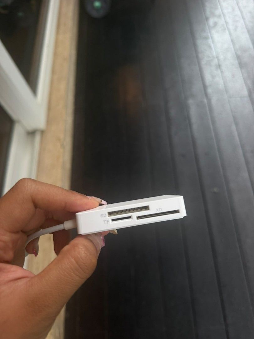 Multi-Card Reader (Category: Cables & Adaptors) located in Singapore. Submitted by nannnng (Listing ID 1460977374, Image 1). Description: - White multi-card reader - Reads SD, TF, and XD cards - Lightning connector for Apple devices (iPhone, iPad) - Compact and portable design - Ideal for on-the-go photo and file transfers.