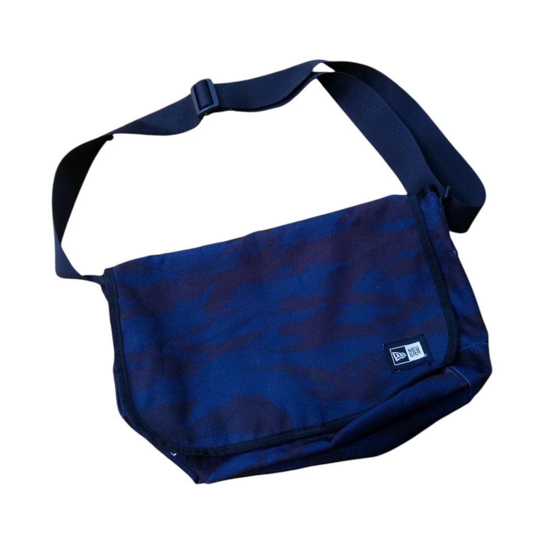New Era Camo Messenger Bag (Category: Sling Bags) located in Cadiz. Submitted by hunteer (Listing ID 1460970733, Image 1). Description: For Sale! ‎ ‎ ‎ ‎New Era Camouflage Shoulder Bag Black/Blue ‎ ‎ ‎ ‎• In Excellent Condition, 9 out of 10 color rate ‎ ‎•100% Polyester ‎ ‎• Legit, check wash tag for authenticity ‎ ‎• Color: Camouflage ‎ ‎• Dimes: Direct Chat ‎ ‎• Issue: Sign of Usage ‎ ‎• Ready for shipping, fix price ‎ ‎• See photos (lighting m