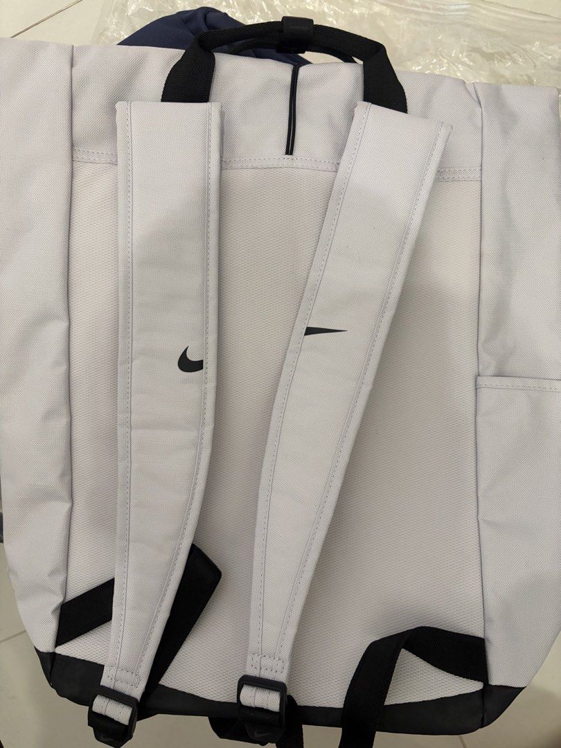 Nike Backpack (Category: Backpacks) located in Singapore. Submitted by littlebluemonster (Listing ID 1460972731, Image 2). Description: - Brand: Nike - Color: Light Grey with Black accents - Features: 'Just Do It' slogan on front panel, adjustable straps - Style: Versatile for daily use, school, or gym.