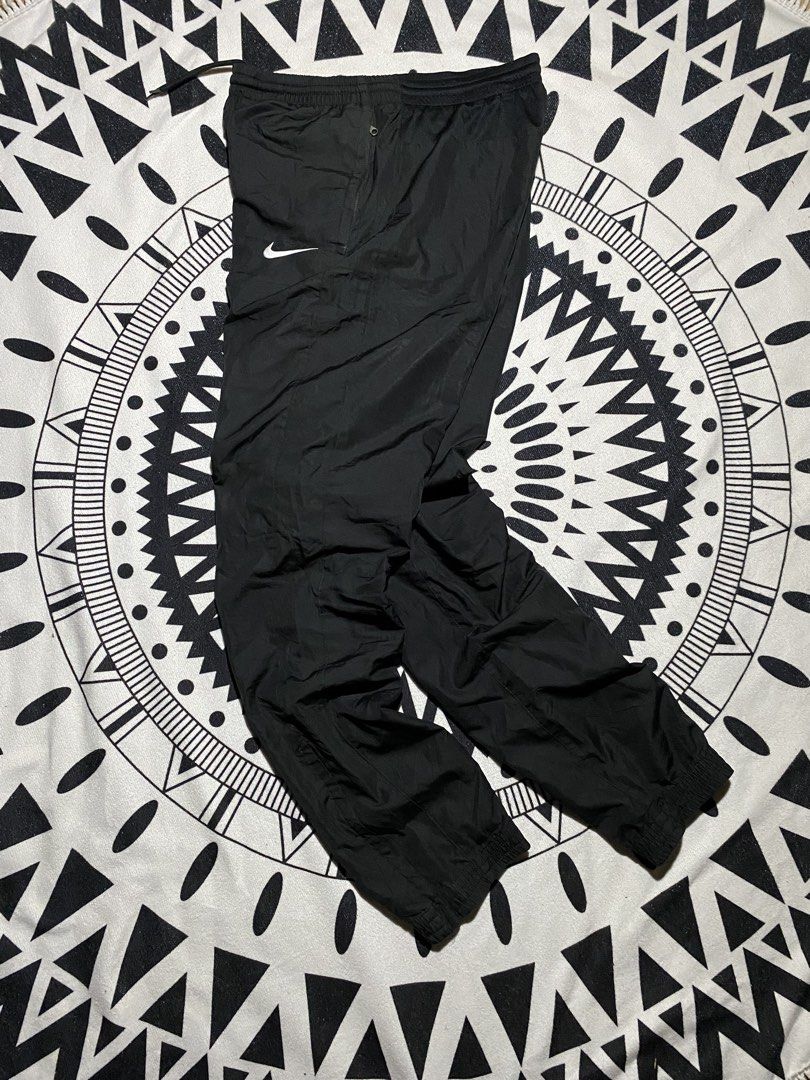 Nike Black Track Pants Joggers (Category: Joggers) located in Badiangan. Submitted by iralorana.thrift (Listing ID 1461065842, Image 1). Description: - Black Nike track pants - Elastic waistband with drawstring - Cuffed ankles - Small Nike logo on left thigh - Versatile for casual wear or sports - Easy to pair with any top.