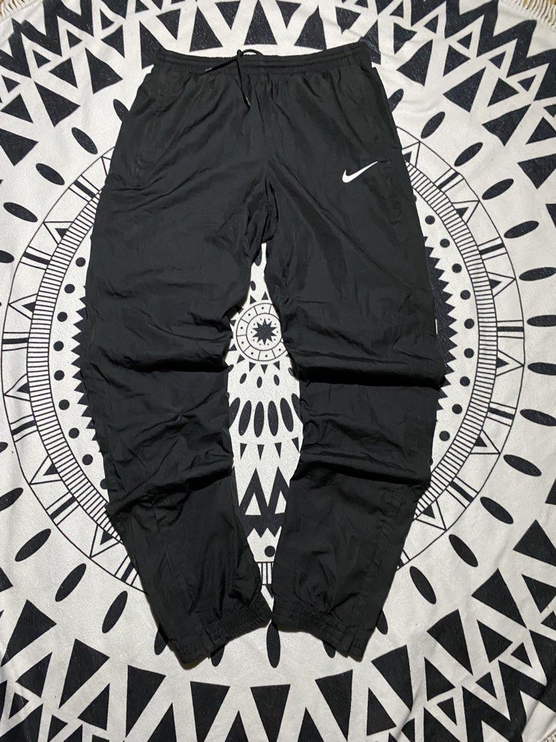 Nike Black Track Pants Joggers (Category: Joggers) located in Badiangan. Submitted by iralorana.thrift (Listing ID 1461065842, Image 2). Description: - Black Nike track pants - Elastic waistband with drawstring - Cuffed ankles - Small Nike logo on left thigh - Versatile for casual wear or sports - Easy to pair with any top.