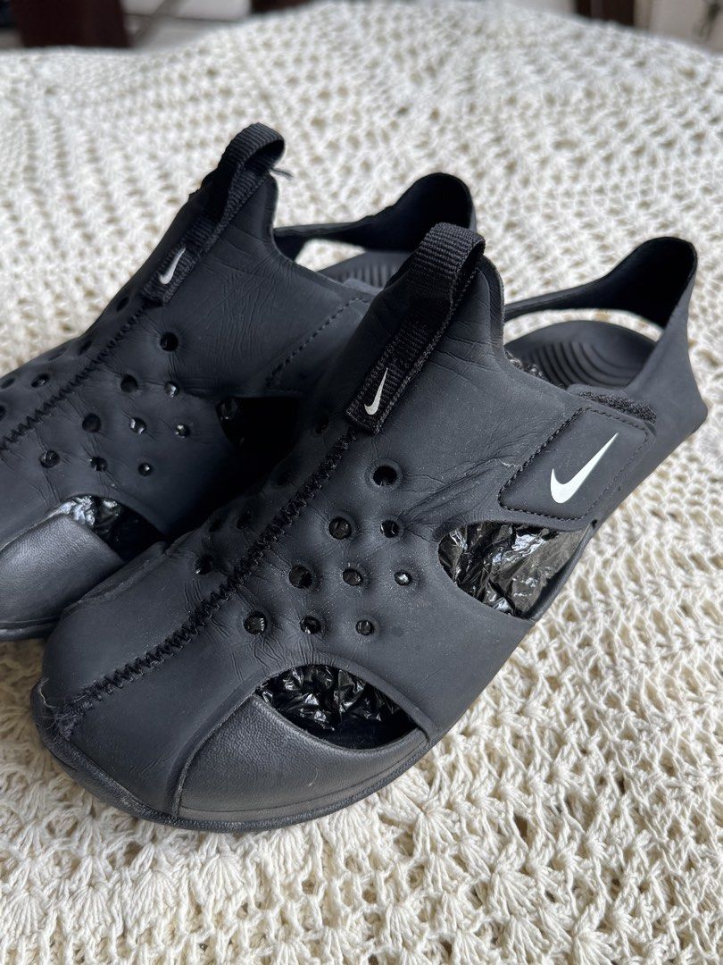 Nike Black Water Sandals (Category: Babies & Kids Fashion) located in Bacolod City. Submitted by vintage_vogue6100 (Listing ID 1461038834, Image 2). Description: - 22.5 to 23 cm - Black Nike water sandals - Ideal for beach or pool days - Easy slip-on and off design - Features drainage holes - Great for active kids - Minor scuffs from normal wear.