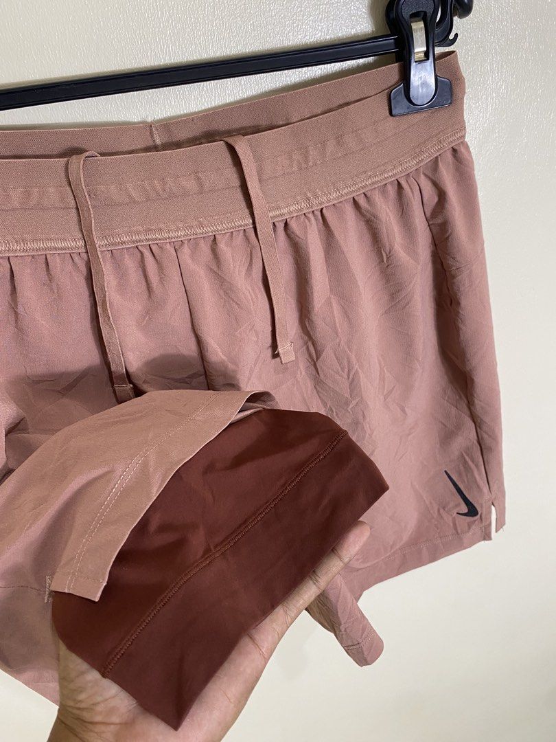 Nike Men's Running Shorts Pink (Category: Activewear) located in Cebu City. Submitted by theloose.thread (Listing ID 1461078781, Image 2). Description: - Light pink Nike running shorts - Features iconic Nike swoosh logo - Double layer design for enhanced comfort and support - Versatile: Ideal for running, workouts, or everyday casual wear.