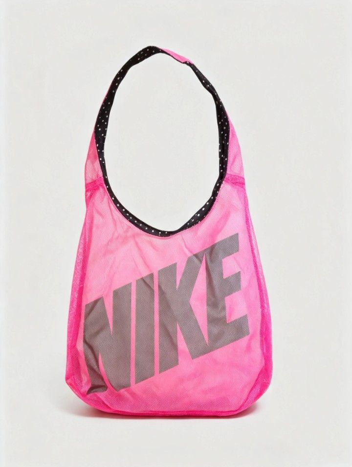 Nike Pink Mesh Tote Bag (Category: Tote Bags) located in Quezon City. Submitted by store.collections (Listing ID 1461085659, Image 1). Description: - Bright pink Nike tote bag - Lightweight mesh material - Black and white polka dot lining - Large Nike logo on the front - Ideal for gym sessions or everyday errands - Easy to carry and versatile.