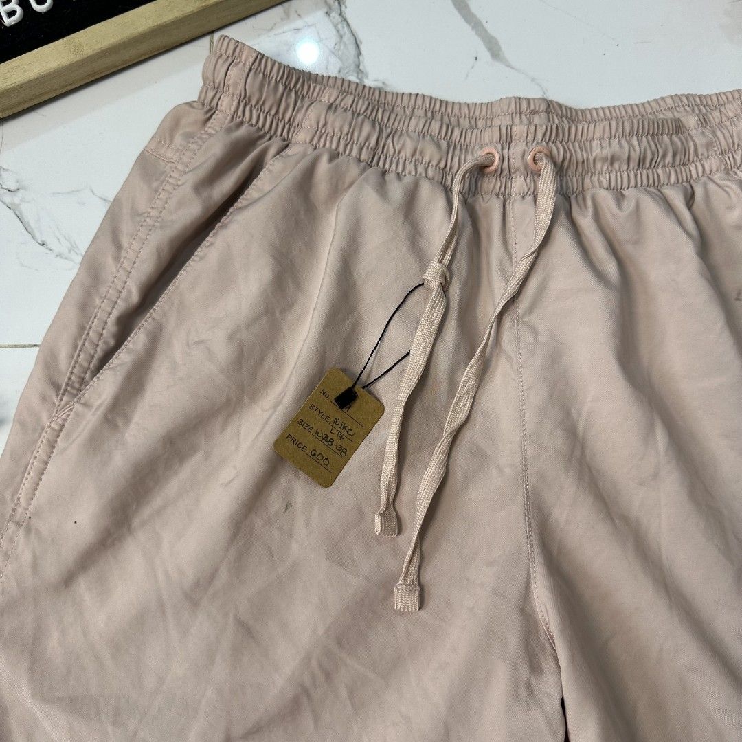 Nike Shorts (Category: Shorts) located in Baguio. Submitted by kayeonlineshop (Listing ID 1461007314, Image 3). Description: light pink Nike woven flow shorts with an elastic drawstring waistband and the Nike logo printed near the hem. l17 w28-38 h25.