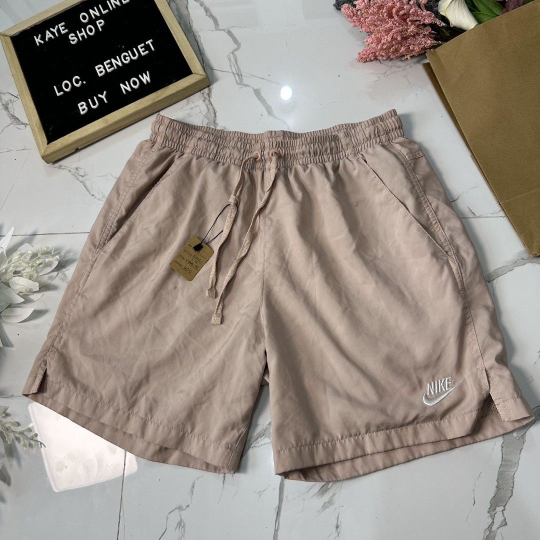 Nike Shorts (Category: Shorts) located in Baguio. Submitted by kayeonlineshop (Listing ID 1461007314, Image 2). Description: light pink Nike woven flow shorts with an elastic drawstring waistband and the Nike logo printed near the hem. l17 w28-38 h25.