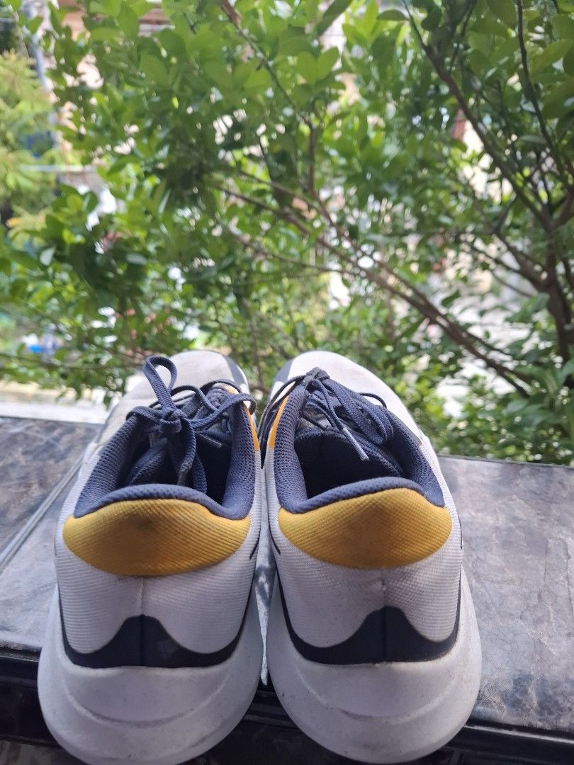 Nike Sneakers (Category: Sneakers & Footwear) located in Manila. Submitted by paosee31 (Listing ID 1461016351, Image 3). Description: - Grey and navy blue Nike sneakers - Yellow accents on tongue and heel - Lace-up closure - Suitable for basketball - Minor scuffs on soles.