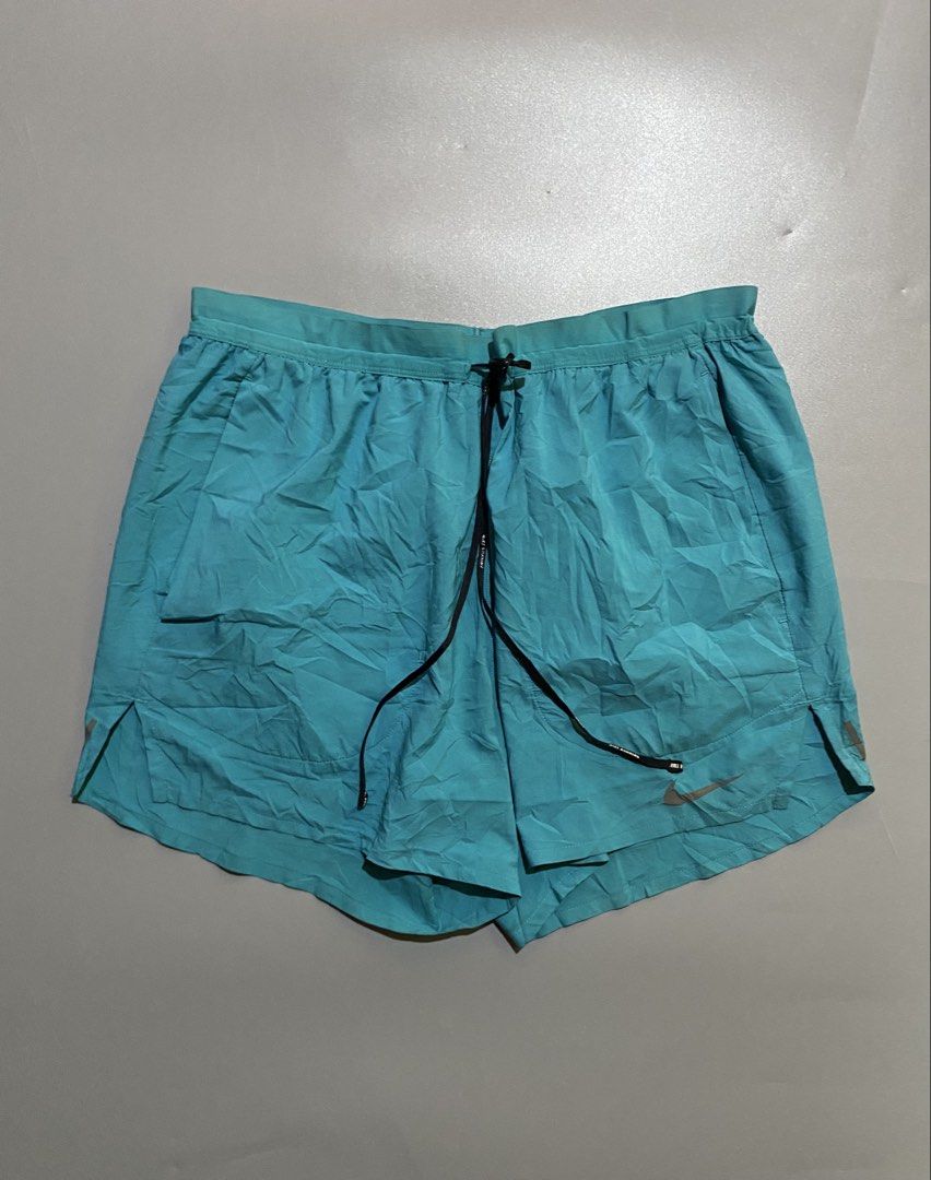 Nike Teal Running Shorts with Zip Pocket (Category: Activewear) located in Manila. Submitted by delunakenn94368 (Listing ID 1460925248, Image 1). Description: - Teal Nike running shorts - Elastic waistband with drawstring - Small zip pocket on the back - Nike logo on the leg - Lightweight material - Ideal for workouts or casual wear.