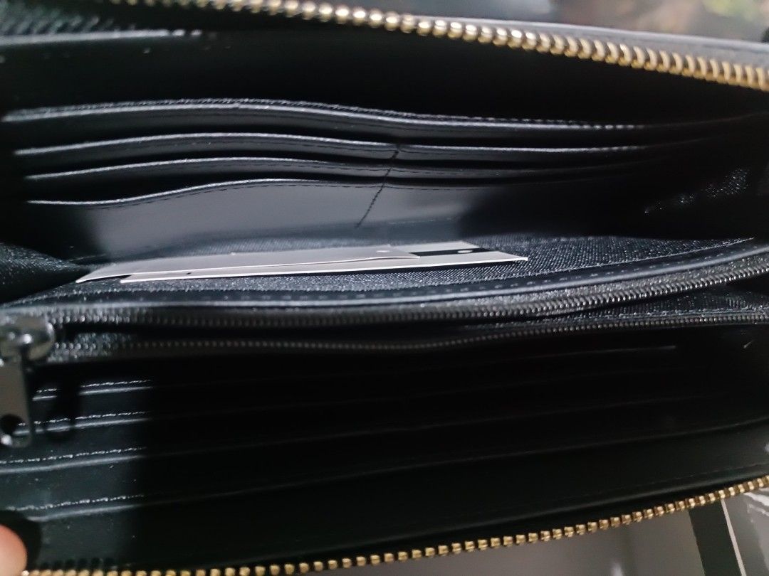 Authentic Nine West Long Wallet for sale! (Category: Wallets & Card holders) located in Cavite. Submitted by Fashion27ph (Listing ID 1461095847, Image 2). Description: - Authentic Nine West long wallet - Elegant black textured exterior with Nine West logo - Includes original box - Spacious interior with multiple card slots and compartments - Ideal for everyday essentials and organization - Perfect for daily use.