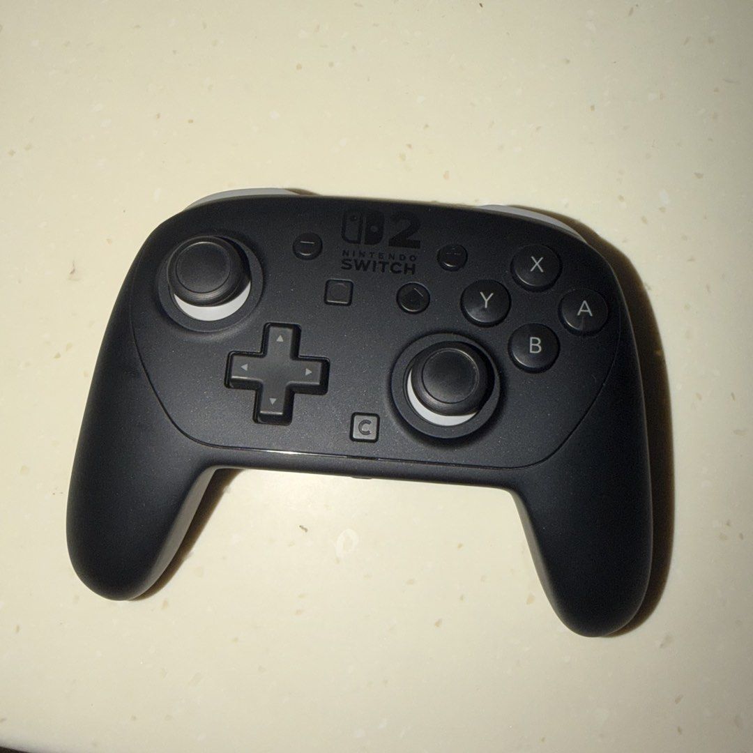 Switch 2 Pro Controller (Category: Controllers) located in Singapore. Submitted by wasapi (Listing ID 1460926296, Image 1). Description: - Nintendo Switch Pro 2 Controller - Classic Black color - Excellent working condition - Perfect for your next gaming adventure - Ready for immediate play! controller and box.
