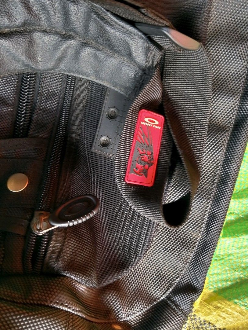Oakley Software Black Duffle Bag (Category: Backpacks) located in Polomolok. Submitted by aldrex_18 (Listing ID 1461113827, Image 3). Description: - Authentic Oakley duffle bag - Ideal for travel or gym sessions - Multiple compartments and zippers for organized storage - Features Oakley logo, 'Factory Pilot', and 'Warning' patches - Adjustable straps for comfortable carrying.
